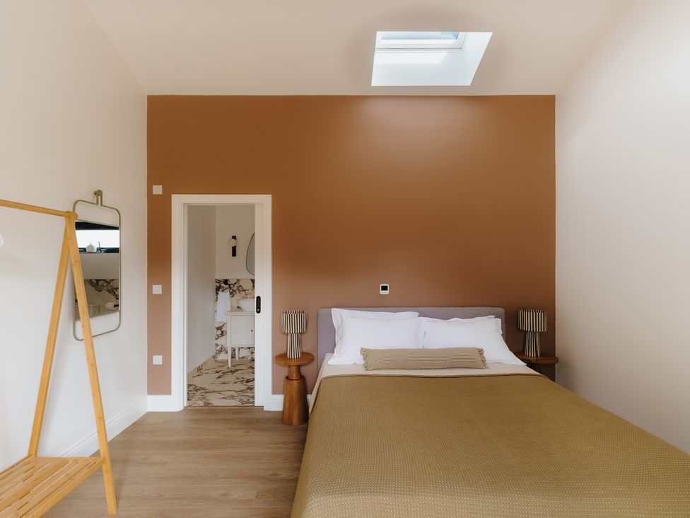 A bedroom with a bed and bedside table at Baldslow Barn in Battle near Hastings
