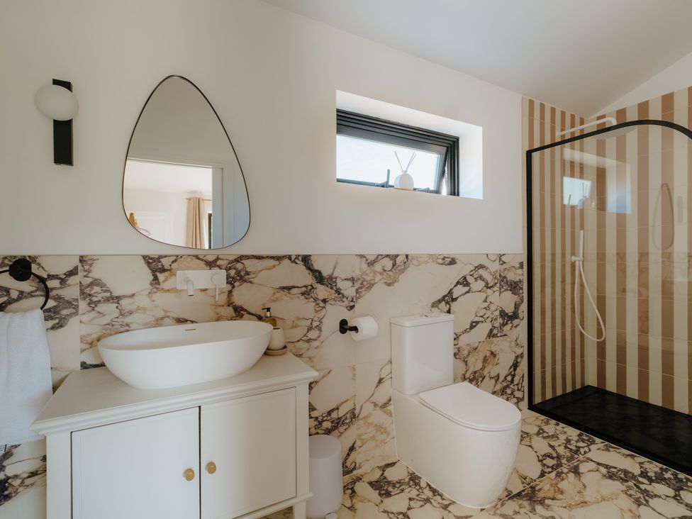 A bathroom with a shower and sink at Baldslow Barn in Battle near Hastings
