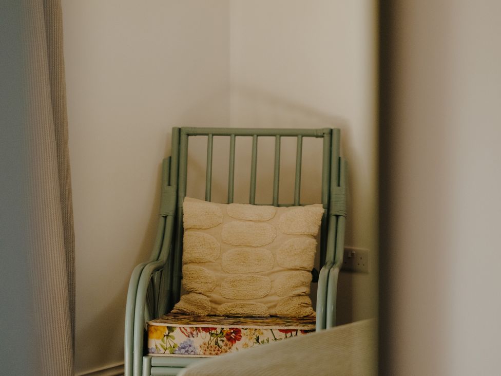 A chair with cushion in a corner at Baldslow Barn near Hastings