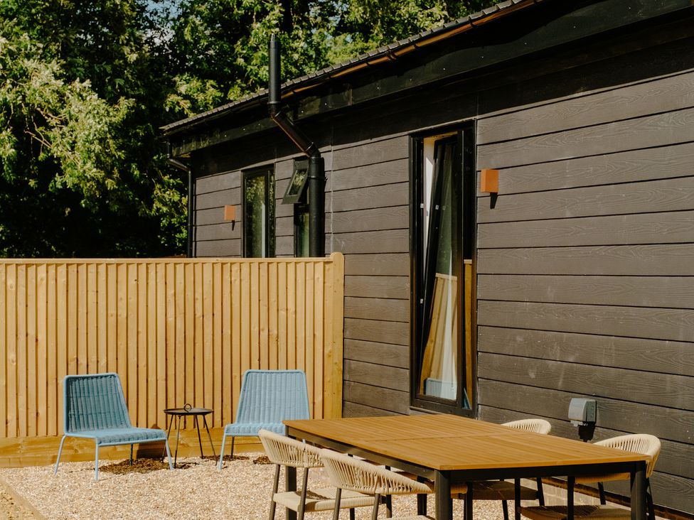 An outdoor area with a table and chairs at Baldslow Barn Battle near Hastings