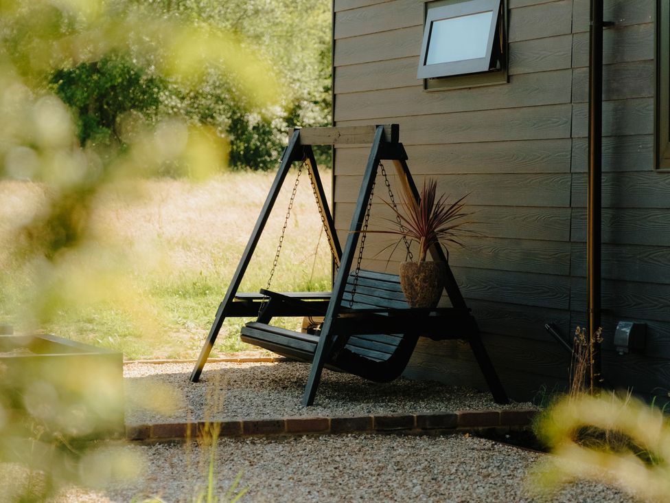 A swing chair with a potted plant at Baldslow Barn in Battle near Hastings