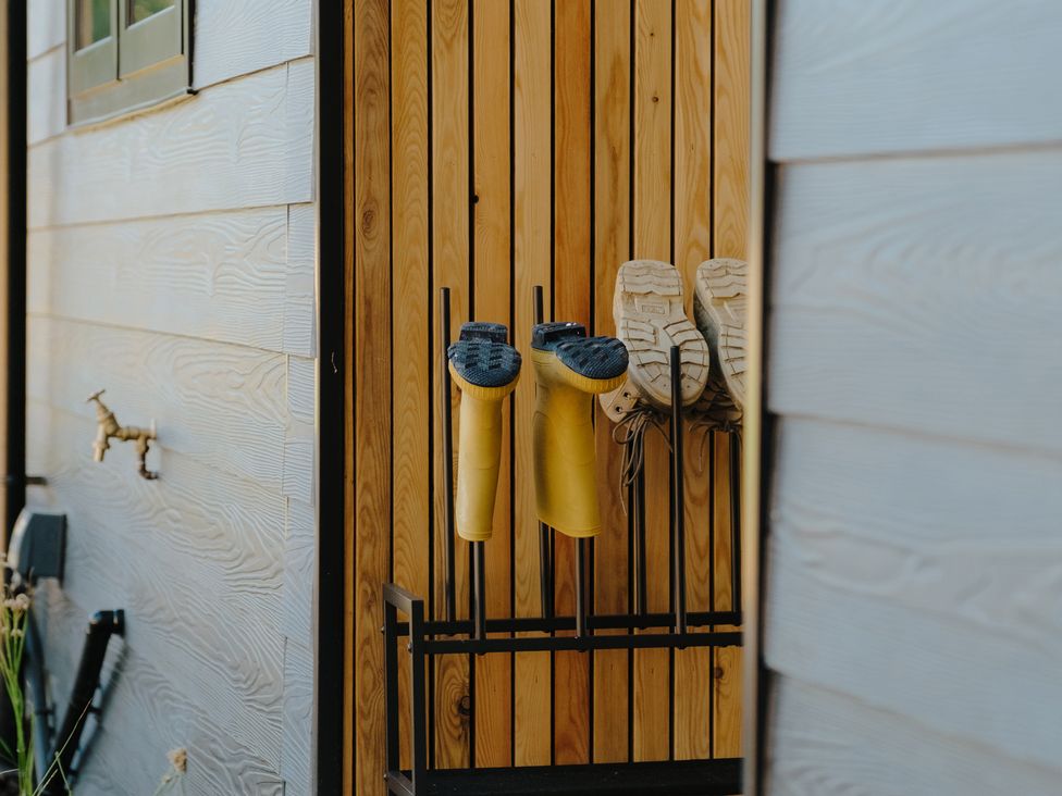 Yellow boots and sneakers on a shoe rack at Baldslow Barn in Battle near Hastings