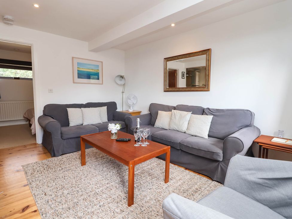 A living room with a sofa and coffee table at Iris at Stancombe Manor, Sherford near Chillington