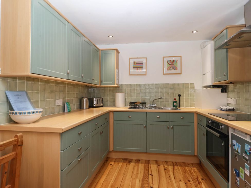 A kitchen with cabinets, sink, and appliances at Iris at Stancombe Manor Sherford near Chillington