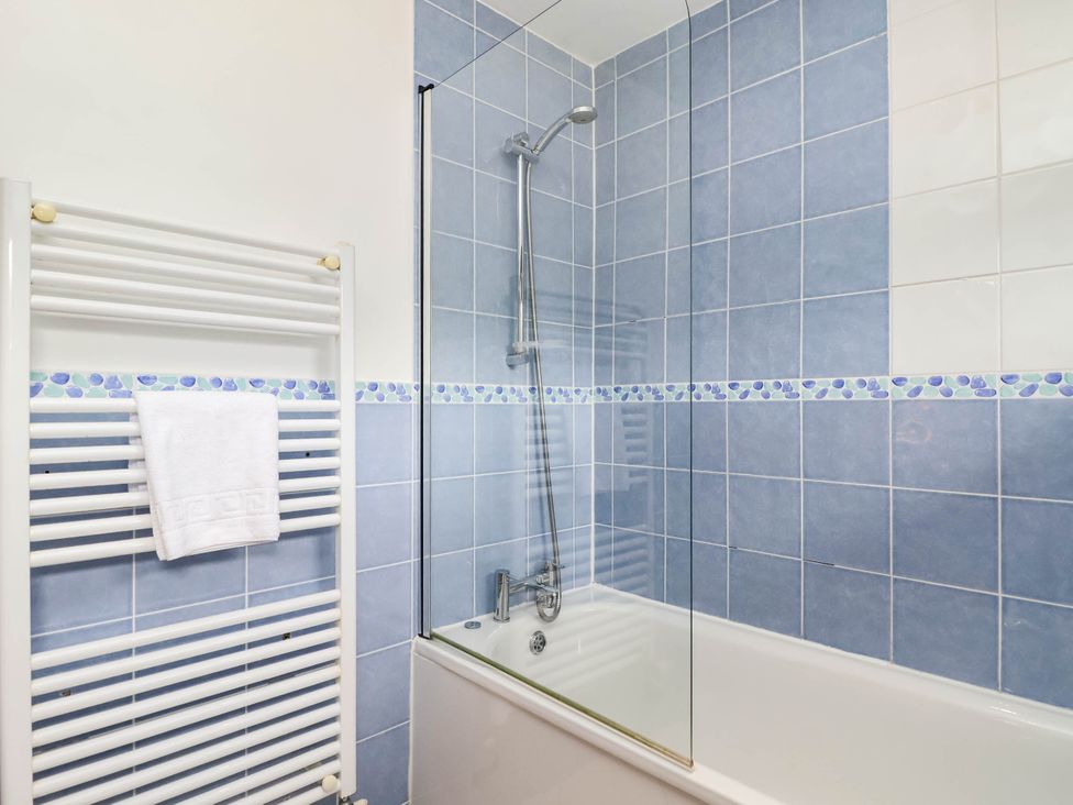 A bathroom with a bathtub and shower at Iris at Stancombe Manor in Sherford near Chillington