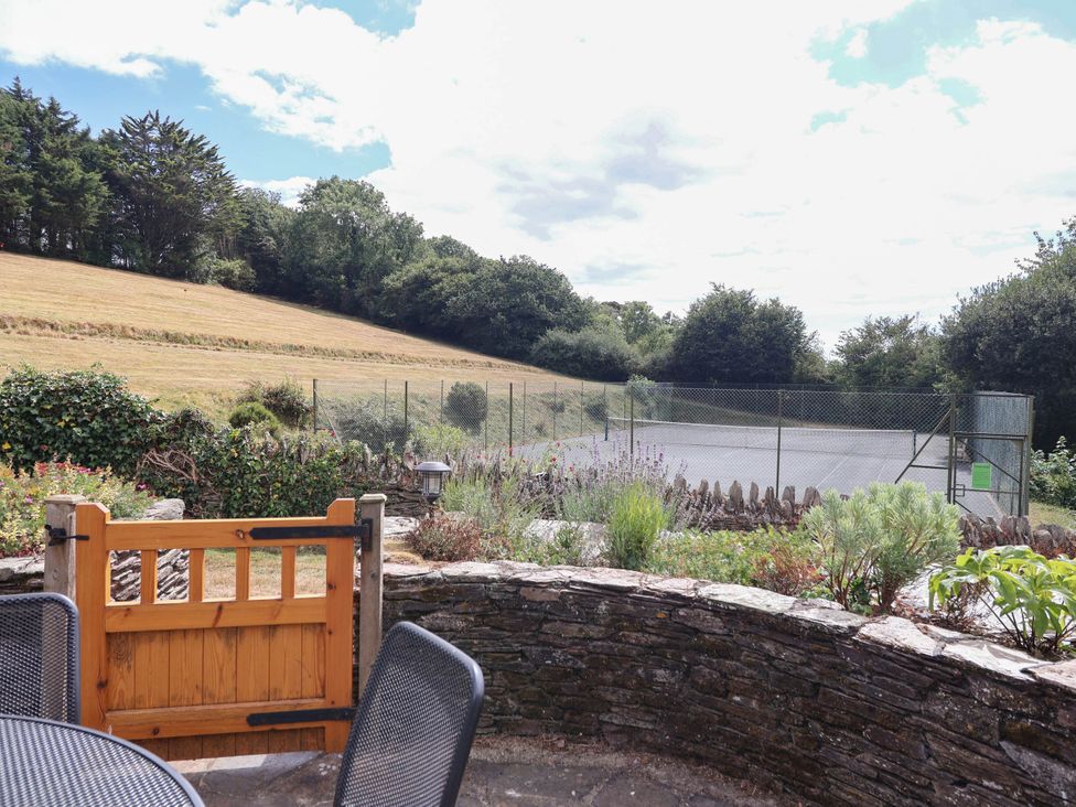 A garden with a tennis court view at Iris at Stancombe Manor Sherford near Chillington