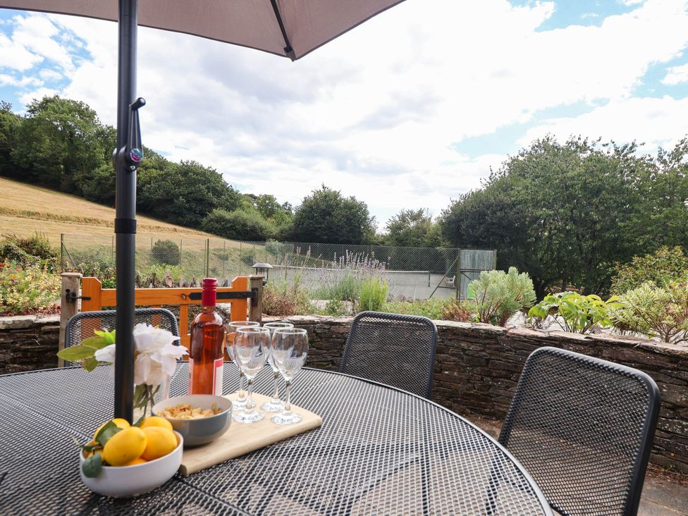 A table with drinks and snacks in a garden at Iris at Stancombe Manor Sherford near Chillington