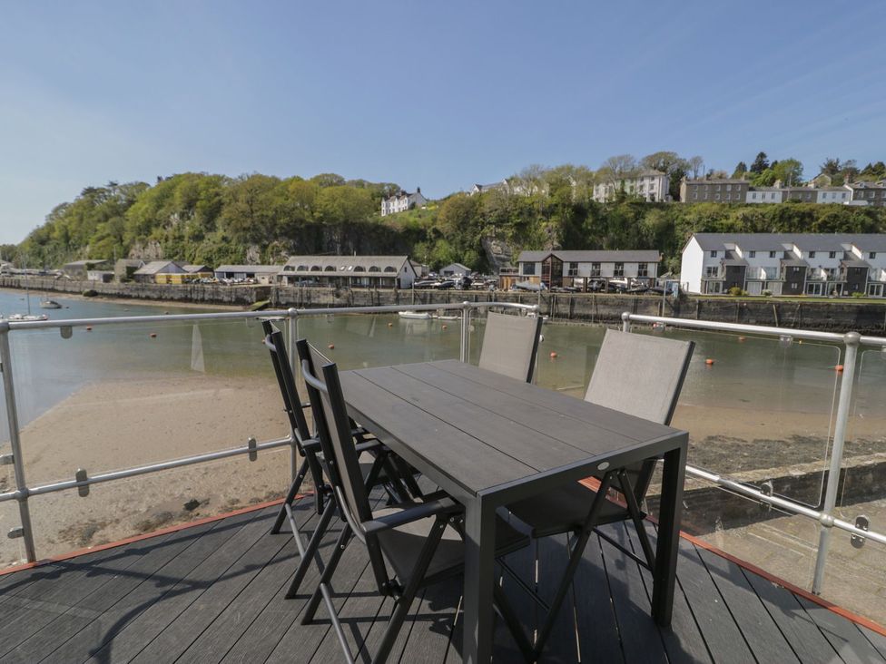 A table and chairs near the water at Seafarer's Haven in Porthmadog