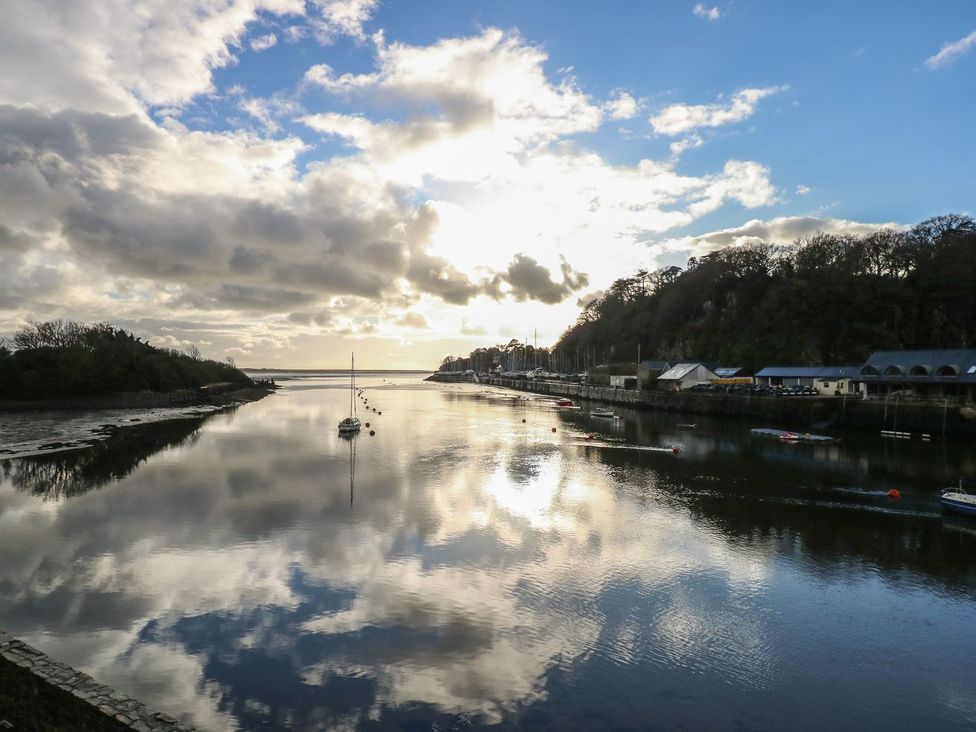 A river with boats and reflections at Seafarer's Haven Porthmadog