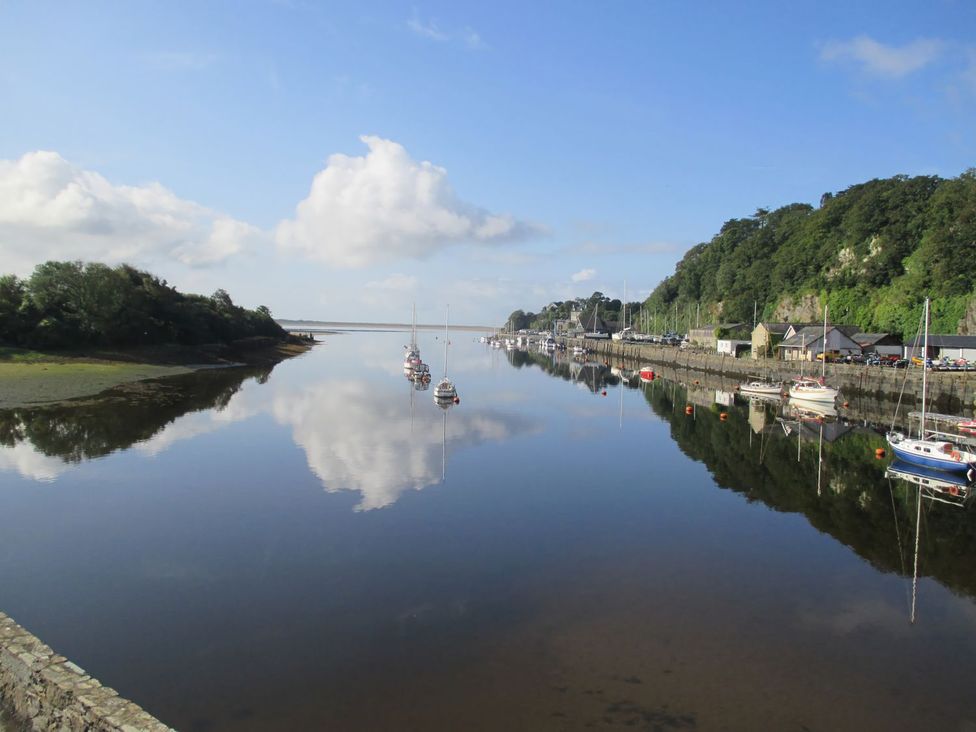 A marina with boats on water at Seafarer's Haven in Porthmadog