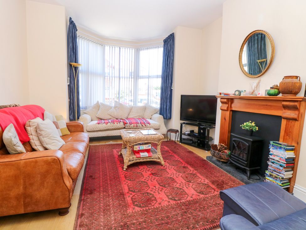 A living room with a sofa and television at 33 North Denes in Great Yarmouth