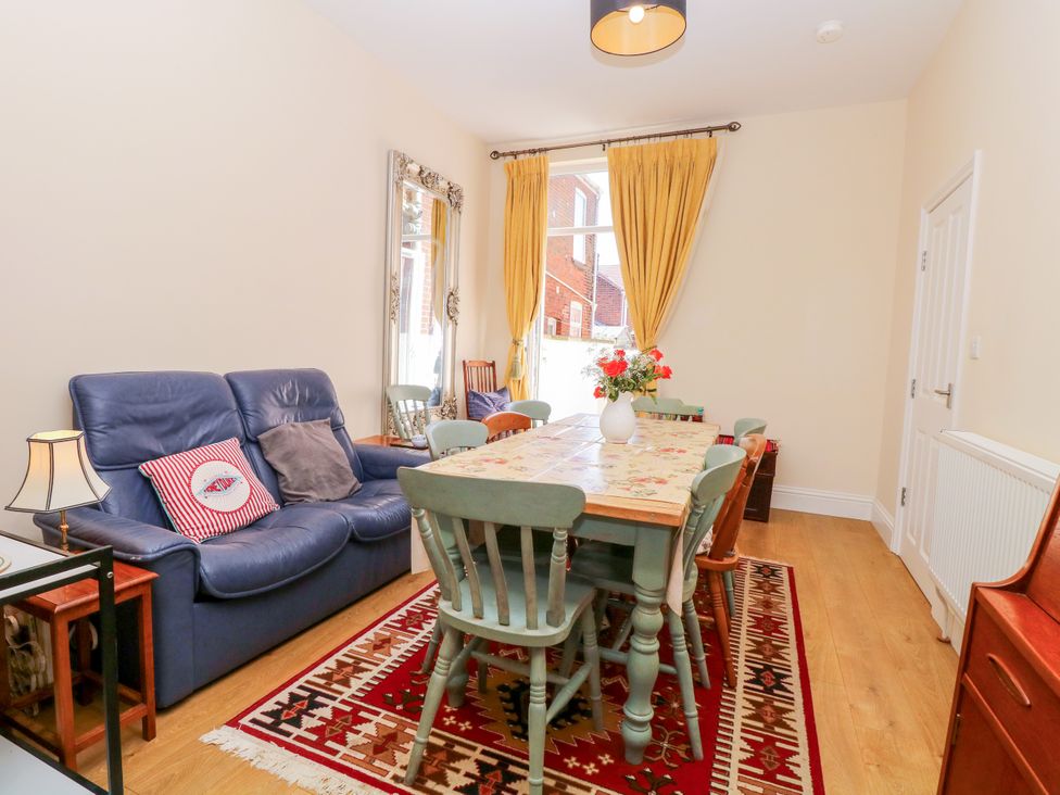 A dining room with a table and chairs at 33 North Denes in Great Yarmouth