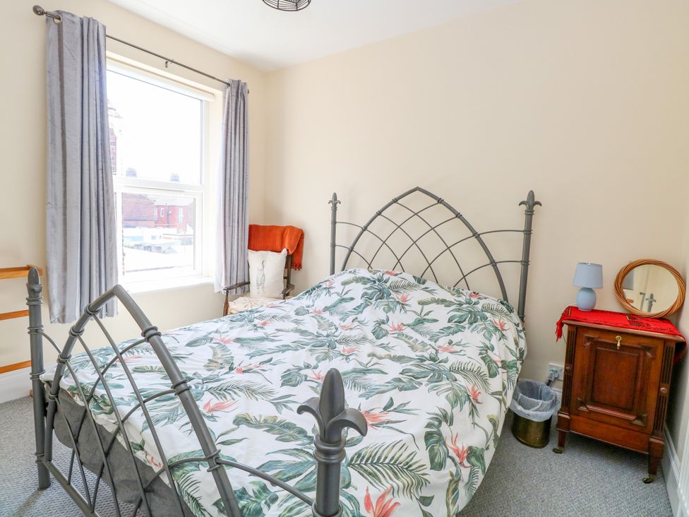 A bedroom with a bed and window at 33 North Denes in Great Yarmouth