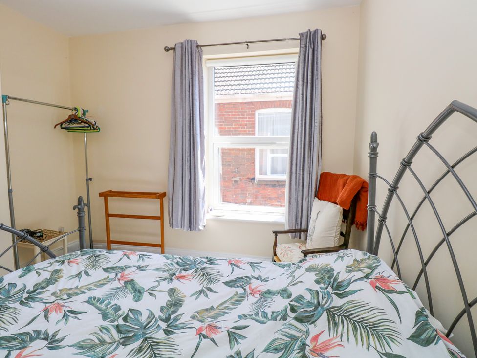 A bedroom with a bed and a window at 33 North Denes in Great Yarmouth