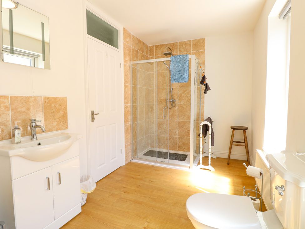A bathroom with a shower, sink, and toilet at 33 North Denes in Great Yarmouth