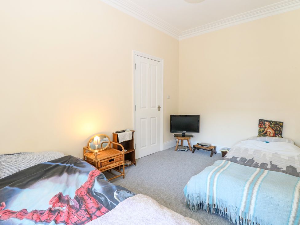 A bedroom with two beds and a television at 33 North Denes in Great Yarmouth