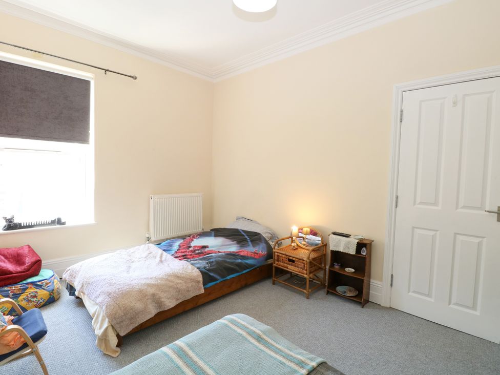 A bedroom with a bed and nightstand at 33 North Denes in Great Yarmouth