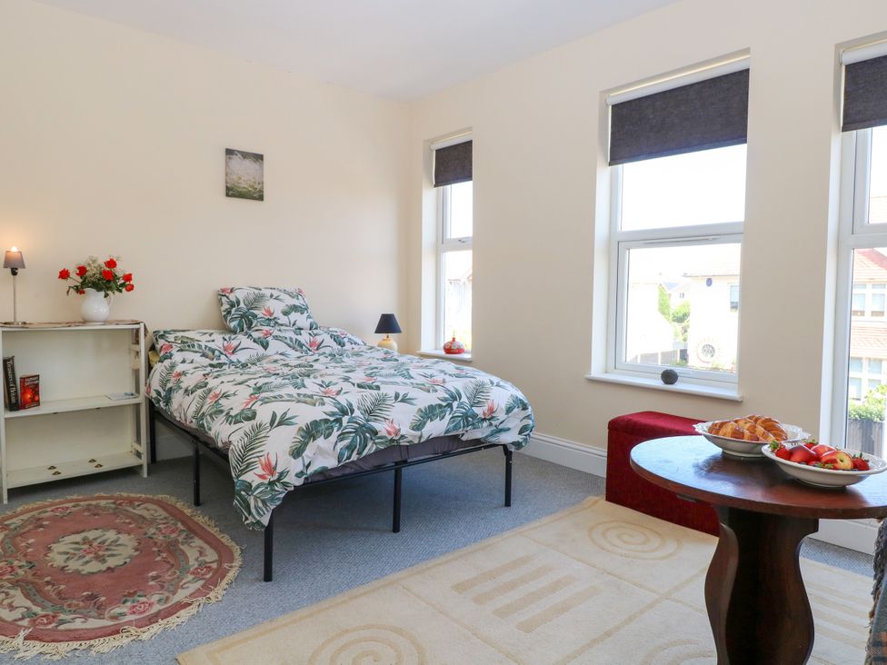 A bedroom with a bed and a table displaying fruit at 33 North Denes in Great Yarmouth