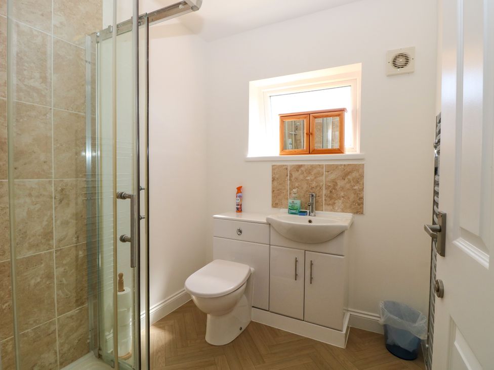 A bathroom with a shower, sink, and toilet at 33 North Denes in Great Yarmouth