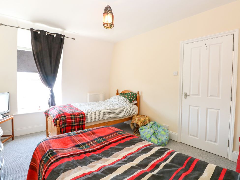 A bedroom with two beds and a television at 33 North Denes in Great Yarmouth