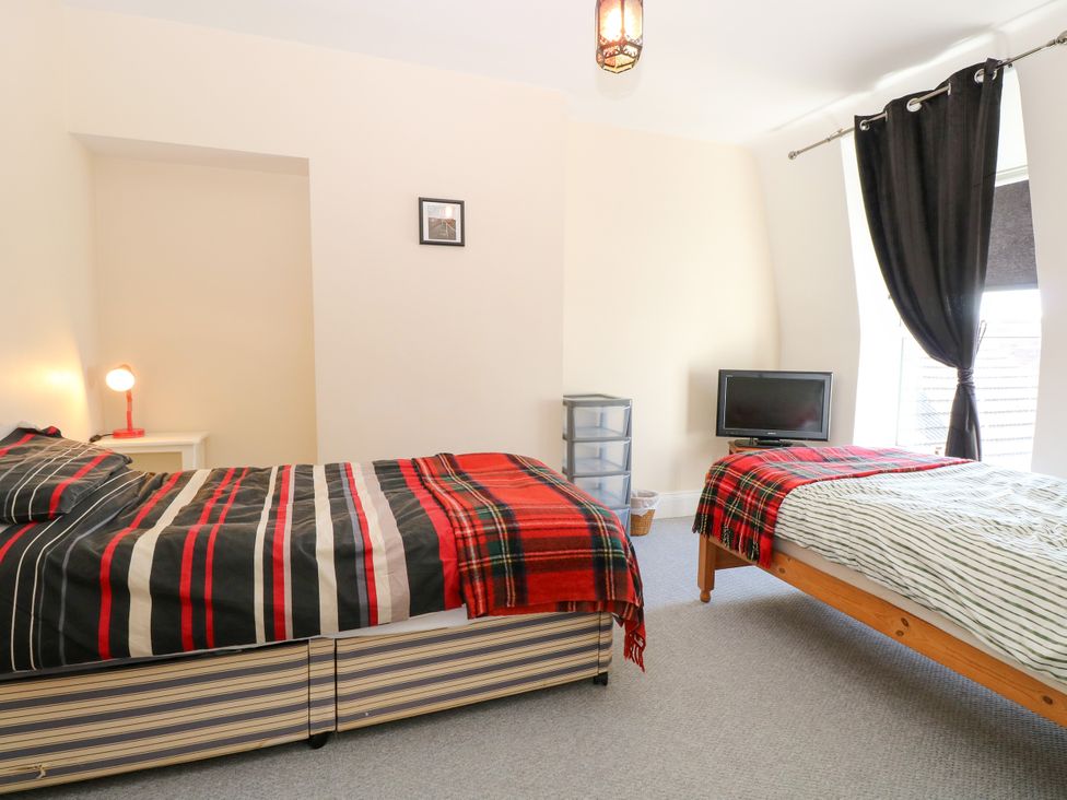 A bedroom with two beds and a television at 33 North Denes in Great Yarmouth