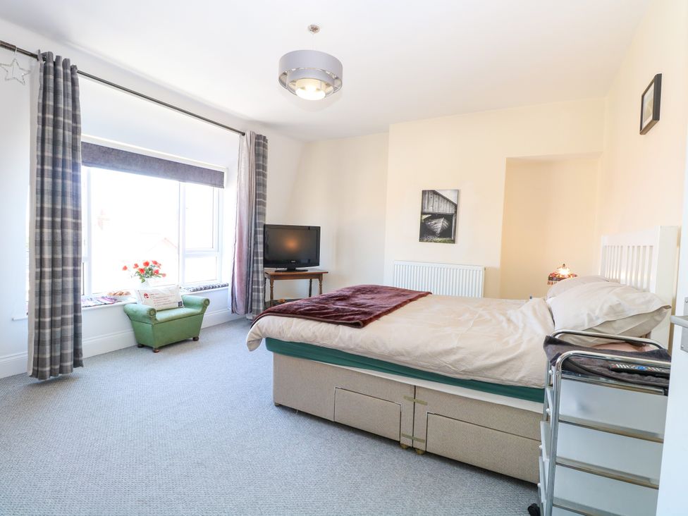 A bedroom with a bed and television at 33 North Denes in Great Yarmouth
