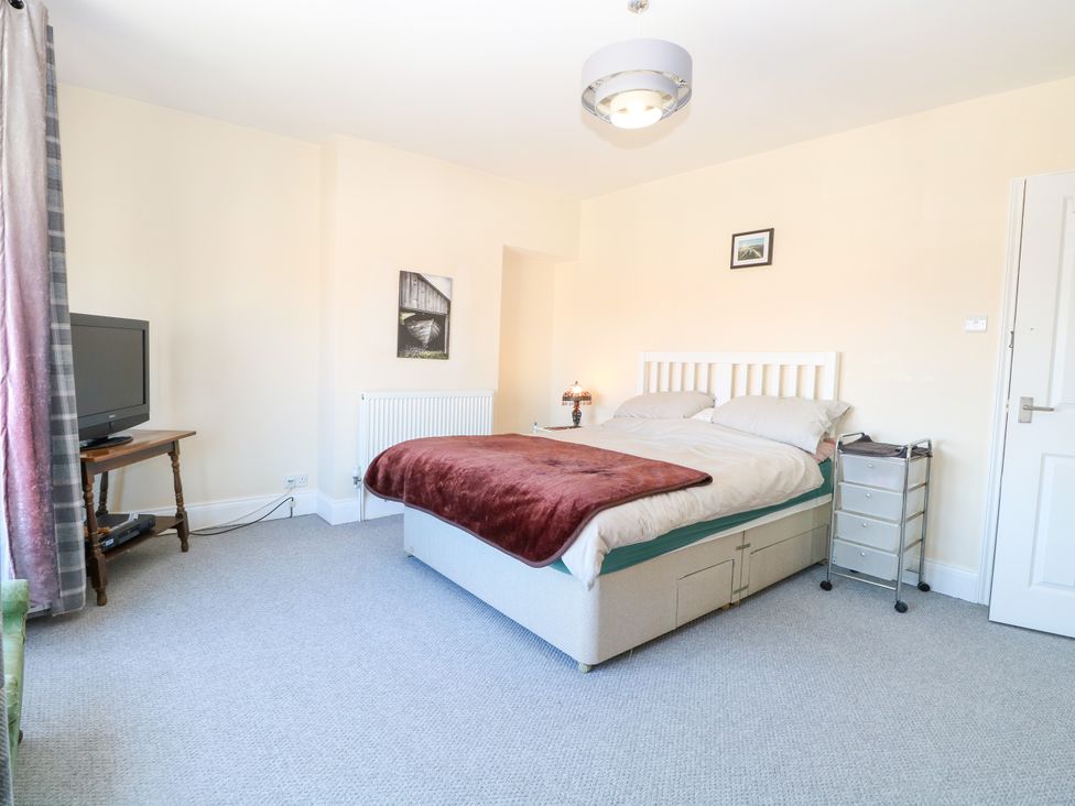 A bedroom with a bed and television at 33 North Denes in Great Yarmouth