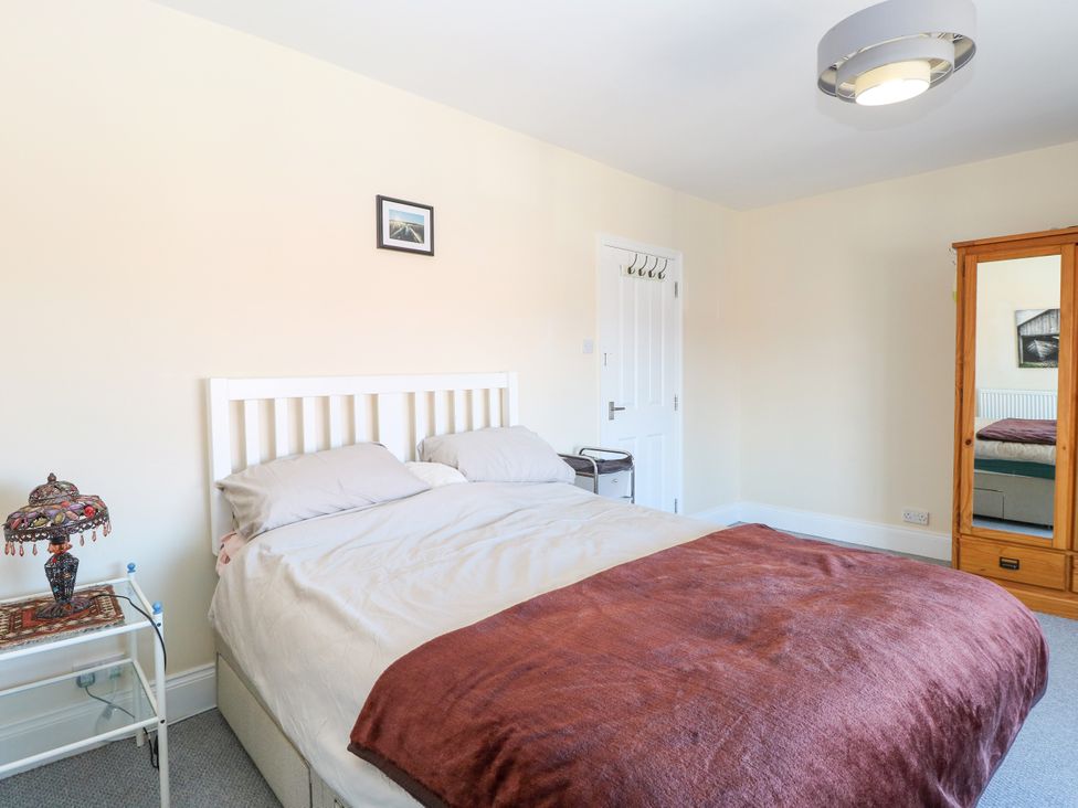 A bedroom with a bed and bedside table at 33 North Denes in Great Yarmouth