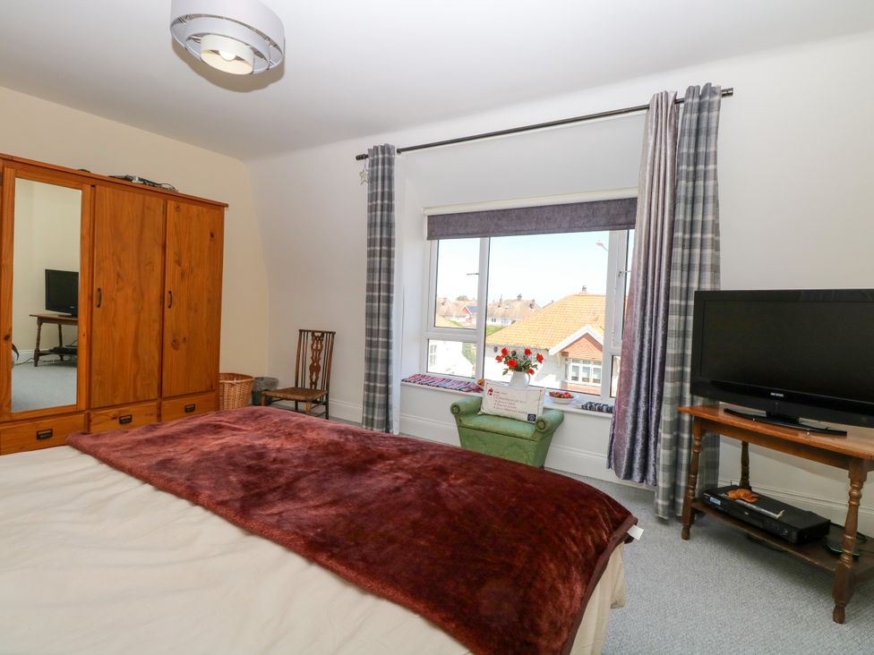 A bedroom with a bed and wardrobe at 33 North Denes in Great Yarmouth