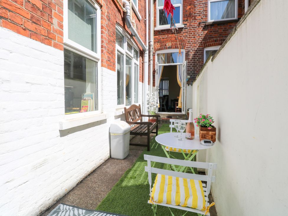An outdoor area with a table and chairs at 33 North Denes in Great Yarmouth