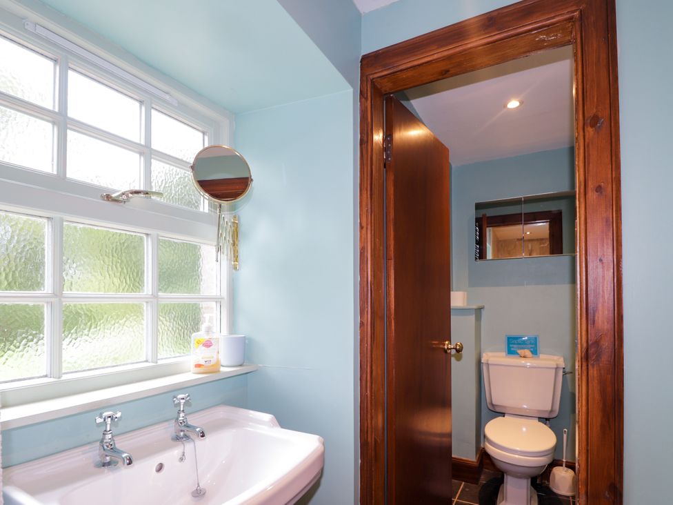 A bathroom with a sink and toilet at Tressady Coach House in Rogart