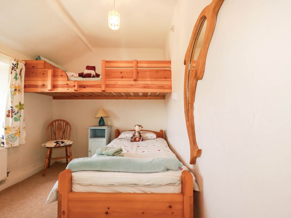 A bedroom with a bunk bed and a chair at The Granary in 