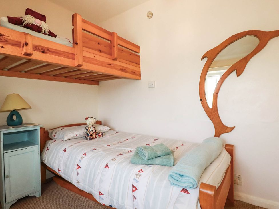 A bedroom with a bunk bed and nightstand at The Granary in 
