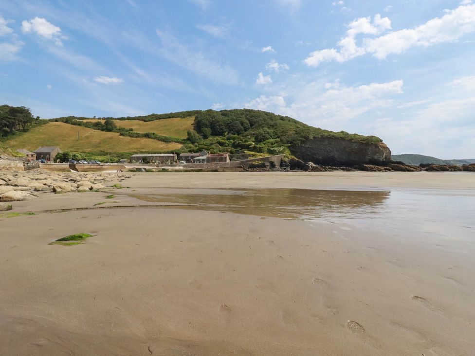 A beach with water and buildings at The Granary in 