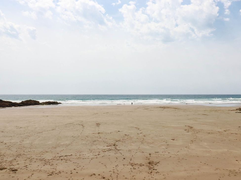 A beach scene with sand and ocean waves at The Granary in 