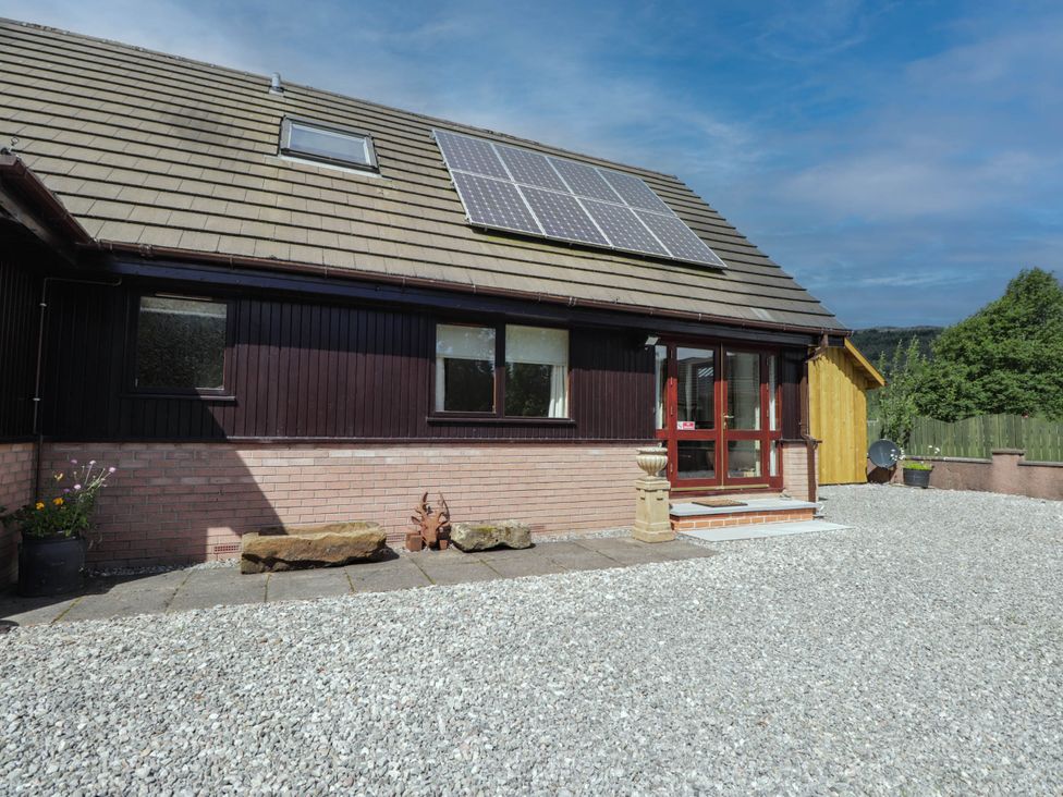An outdoor view of a house with solar panels at Park House Cannich Holiday Retreat in Cannich