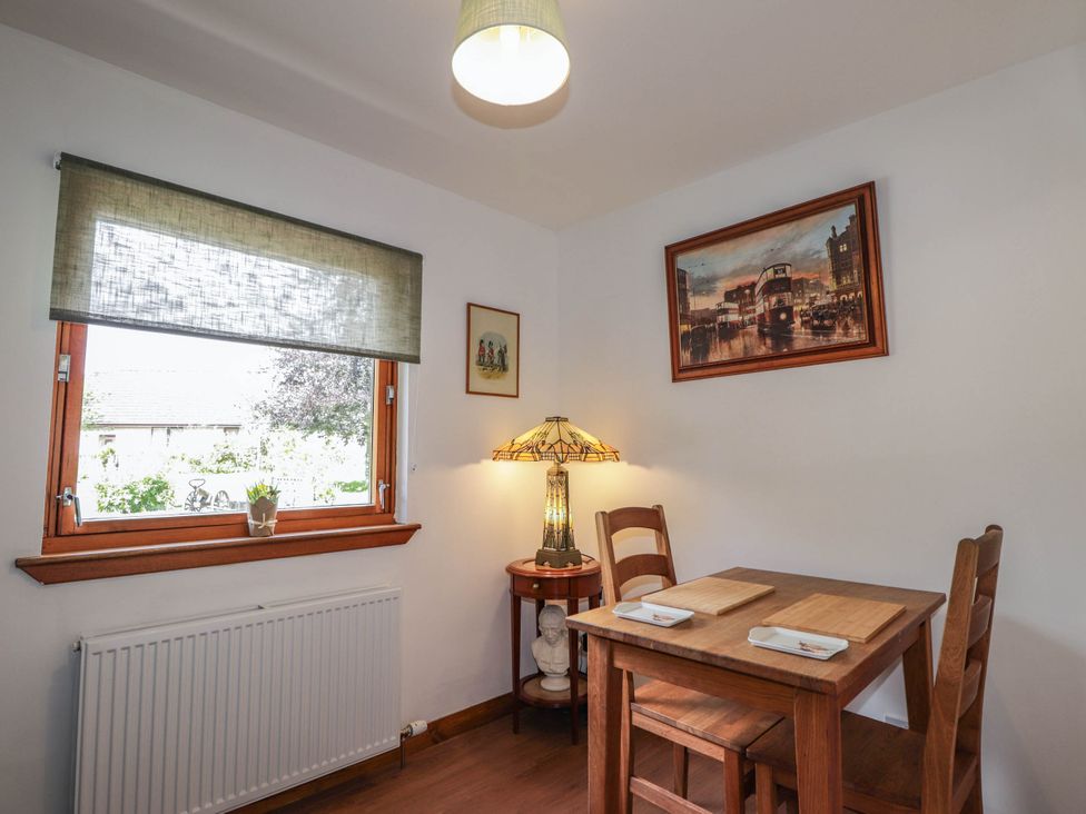 A dining room with a table and chairs at Park House Cannich Holiday Retreat, Cannich