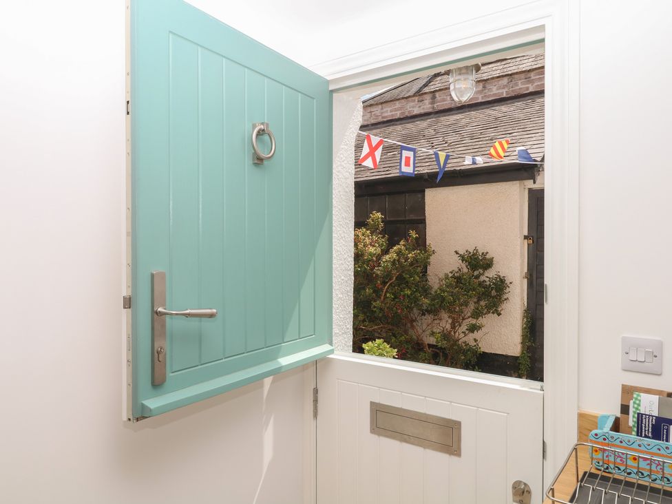 An entrance view with an open door and flags outside at Tower View Cottage in Lympstone