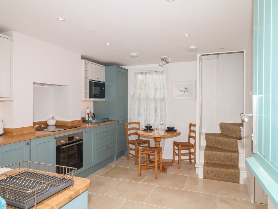 A kitchen with a round table and chairs at Tower View Cottage in Lympstone
