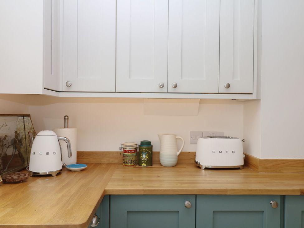 A kitchen with kettle and toaster on countertop at Tower View Cottage Lympstone