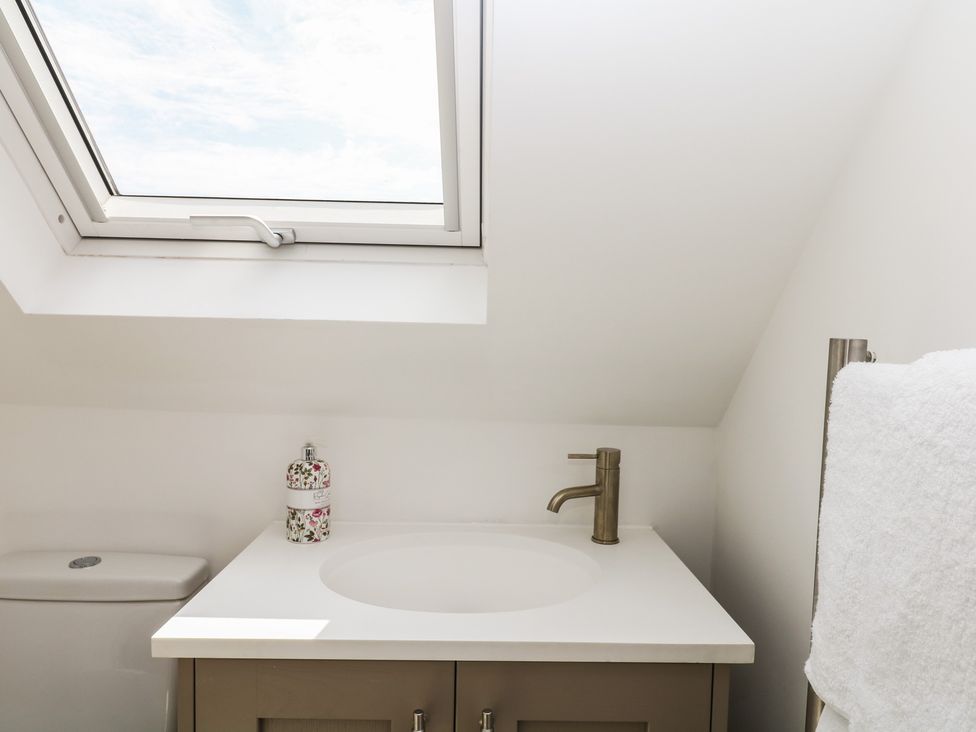A bathroom with a sink and toilet at Tower View Cottage in Lympstone