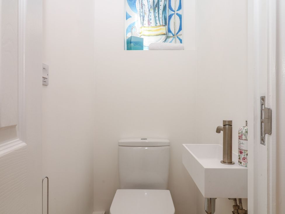 A bathroom with a toilet and sink at Tower View Cottage in Lympstone