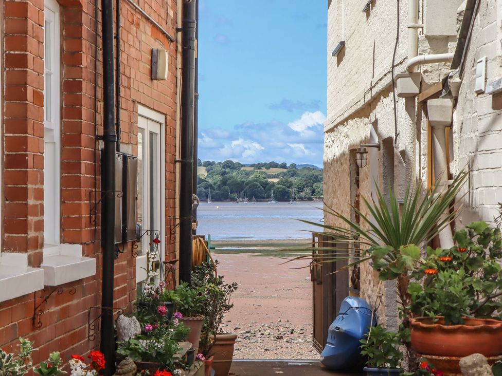 A view between buildings towards the beach at Tower View Cottage in Lympstone