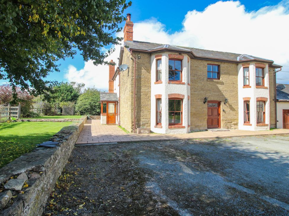 An exterior view of a house with a garden at Stone House Farm in Cobnash near Leominster