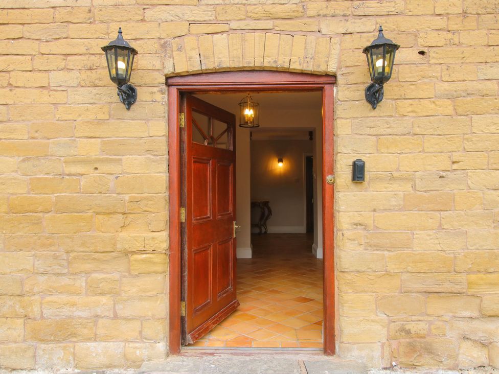 An entrance with an open door and light fixtures at Stone House Farm Cobnash near Leominster