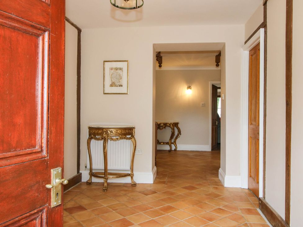 A hallway with a table and door at Stone House Farm Cobnash near Leominster