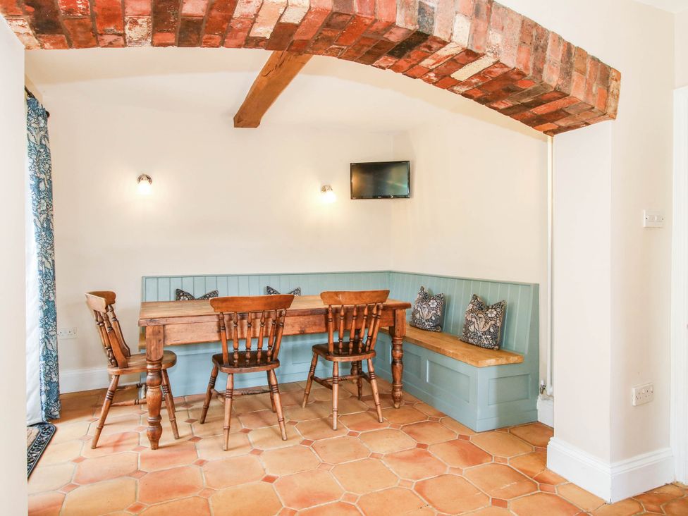 A dining room with a table and chairs at Stone House Farm in Cobnash near Leominster
