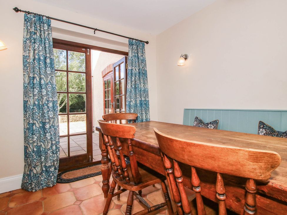 A dining room with a table and chairs at Stone House Farm in Cobnash near Leominster