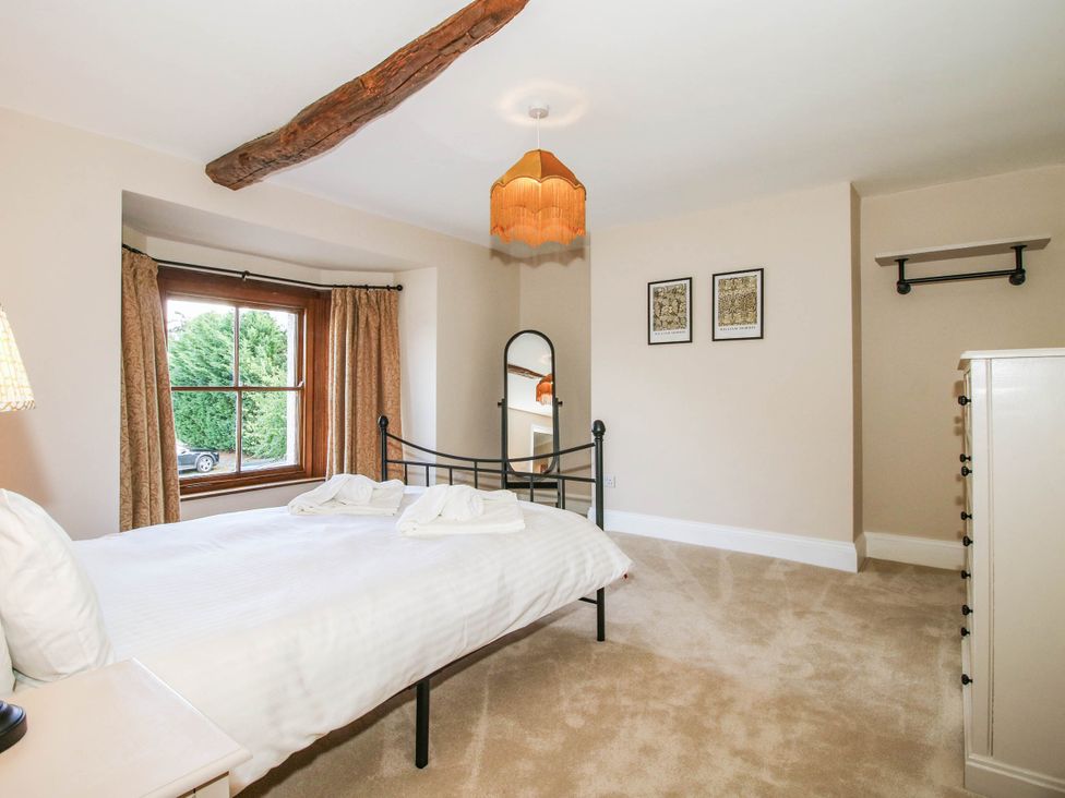 A bedroom with a bed and a window at Stone House Farm in Cobnash near Leominster