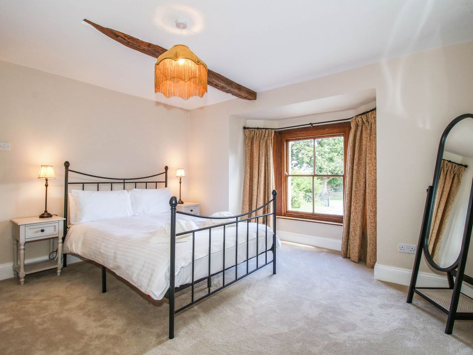 A bedroom with a bed and window at Stone House Farm in Cobnash near Leominster